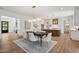 Dining area with stylish lighting fixtures, hardwood floors, and views to chef's kitchen at 217 Dublin Rd, Raleigh, NC 27609