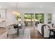 Open dining room featuring modern lighting, hardwood floors, and access to outdoor patio at 217 Dublin Rd, Raleigh, NC 27609