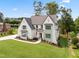 Well-manicured lawn and landscaping enhance this home's curb appeal, with a brick and white facade at 217 Dublin Rd, Raleigh, NC 27609