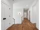 Hallway featuring hardwood floors and white walls, enhanced by a decorative light fixture at 217 Dublin Rd, Raleigh, NC 27609