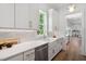 White kitchen has stainless steel appliances, a large window, and ample counter space at 217 Dublin Rd, Raleigh, NC 27609