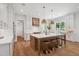 Bright, open kitchen boasts a large island with seating, modern appliances, and stylish pendant lighting at 217 Dublin Rd, Raleigh, NC 27609