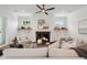 Stylish living room with fireplace, ceiling fan, and built-in shelves at 217 Dublin Rd, Raleigh, NC 27609