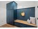 Inviting mudroom with blue cabinets, wood bench, storage and gold hooks at 217 Dublin Rd, Raleigh, NC 27609