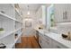 Walk-in pantry with custom shelving, a workstation, and a sink at 217 Dublin Rd, Raleigh, NC 27609