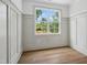 Minimalist room with hardwood flooring, white walls, and a large window for natural light at 217 Dublin Rd, Raleigh, NC 27609