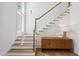 Bright staircase featuring hardwood steps and classic white railing at 217 Dublin Rd, Raleigh, NC 27609