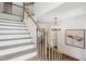 Elegant staircase with light wood treads, white risers, and a gracefully curved handrail at 217 Dublin Rd, Raleigh, NC 27609