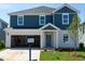 Charming two-story home with a combination of blue and white siding, with an attached garage at 2254 Cherry Creek Rd, Haw River, NC 27258
