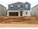 New construction two-story home features a two-car garage and blue vinyl siding at 2254 Cherry Creek Rd, Haw River, NC 27258
