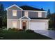 Charming two-story home with gray and beige vinyl siding, an inviting front porch, and green lawn at 2254 Cherry Creek Rd, Haw River, NC 27258