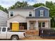New two-story home with a two-car garage, blue and gray siding, and construction in progress at 2291 Cherry Creek Rd, Haw River, NC 27258