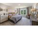 Beautifully staged main bedroom has neutral tones, plush carpet, and a large window at 2291 Cherry Creek Rd, Haw River, NC 27258