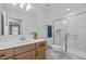 Modern bathroom with a glass shower, white marble tile, and wood vanity at 248 Speight Branch Rd, Cary, NC 27518