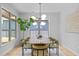 Sunlit dining room with a contemporary light fixture, large windows, and stylish decor at 248 Speight Branch Rd, Cary, NC 27518