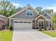 Beautifully maintained home featuring gray siding, stone accents, a two-car garage, and well-kept landscaping at 248 Speight Branch Rd, Cary, NC 27518