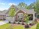 Charming home with a stone and gray siding exterior, manicured landscaping, and an attached two-car garage at 248 Speight Branch Rd, Cary, NC 27518