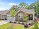 Charming home with a stone and gray siding exterior, manicured landscaping, and an attached two-car garage at 248 Speight Branch Rd, Cary, NC 27518