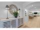 The foyer's decorative mirror and table with lamps, with an archway leading to the kitchen at 248 Speight Branch Rd, Cary, NC 27518