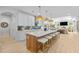 The gourmet kitchen features a large island with counter seating, modern lighting, and stainless steel appliances at 248 Speight Branch Rd, Cary, NC 27518