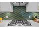 Modern kitchen features stainless steel appliances and a gorgeous backsplash at 248 Speight Branch Rd, Cary, NC 27518