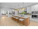 The open-concept kitchen has an expansive island, stainless steel appliances, and seamless flow into the living area at 248 Speight Branch Rd, Cary, NC 27518