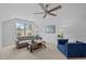 Living room featuring a neutral color palette, ceiling fan, and large windows for natural light at 248 Speight Branch Rd, Cary, NC 27518