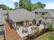 An aerial shot showcasing a spacious outdoor patio area, complete with a fireplace and a dining set at 248 Speight Branch Rd, Cary, NC 27518