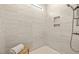 Modern shower featuring stylish gray tiles and a convenient built-in shower niche at 248 Speight Branch Rd, Cary, NC 27518