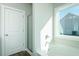 Bathroom with a white tub and shower, complemented by a large window for natural light at 2803 Ricolden Trl, Elon, NC 27244