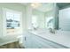 Bright bathroom with double vanity, white cabinets, quartz countertop, and a large window at 2803 Ricolden Trl, Elon, NC 27244
