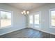 Bright dining area features hardwood floors, chandelier, and French doors to the backyard at 2803 Ricolden Trl, Elon, NC 27244