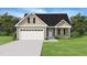 Charming, newly constructed home featuring a gabled roof and a manicured lawn at 2803 Ricolden Trl, Elon, NC 27244