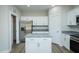Modern kitchen with white cabinets, granite countertops, stainless steel appliances, and an island at 2803 Ricolden Trl, Elon, NC 27244