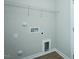 A simple laundry room features white walls, hookups, and wire shelving at 2803 Ricolden Trl, Elon, NC 27244