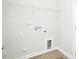 Bright laundry room with white walls, shelving, and utility connections at 2803 Ricolden Trl, Elon, NC 27244