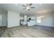 Open-concept living space featuring luxury vinyl plank flooring, modern lighting, and adjacent kitchen at 2803 Ricolden Trl, Elon, NC 27244
