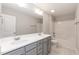 Bright bathroom featuring a double sink vanity with grey cabinets and a shower-tub combination at 3001 Sadie Hopkins St, Raleigh, NC 27616