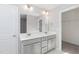 Bathroom featuring a double sink vanity, large mirror, and modern lighting at 3001 Sadie Hopkins St, Raleigh, NC 27616