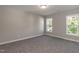 Bedroom featuring neutral walls, plush carpeting, and windows that provide natural light at 3001 Sadie Hopkins St, Raleigh, NC 27616