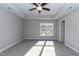 Spacious bedroom with plush carpeting, a tray ceiling and natural light from a large window at 3001 Sadie Hopkins St, Raleigh, NC 27616