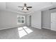 Spacious bedroom with plush carpeting, a tray ceiling and natural light from a large window at 3001 Sadie Hopkins St, Raleigh, NC 27616
