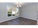 Bright dining area with a modern chandelier and large window offering natural light at 3001 Sadie Hopkins St, Raleigh, NC 27616