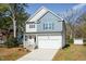 Charming two-story home featuring a blend of light siding and blue shingle accents at 3001 Sadie Hopkins St, Raleigh, NC 27616