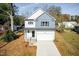 Charming two-story home features a blend of light siding and blue shingle accents at 3001 Sadie Hopkins St, Raleigh, NC 27616