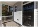 Inviting covered front porch with a sleek black front door at 3001 Sadie Hopkins St, Raleigh, NC 27616