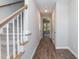 Hallway with wood floors leads to the stairs and several doorways at 3001 Sadie Hopkins St, Raleigh, NC 27616