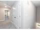 Upstairs hallway with access to bedrooms and storage, featuring carpeted floors and neutral walls at 3001 Sadie Hopkins St, Raleigh, NC 27616