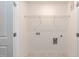 Bright laundry room featuring tile floors, a wire shelf, and convenient utility connections at 3001 Sadie Hopkins St, Raleigh, NC 27616