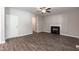 Open-concept living space featuring fireplace, ceiling fan, and access to the backyard at 3001 Sadie Hopkins St, Raleigh, NC 27616